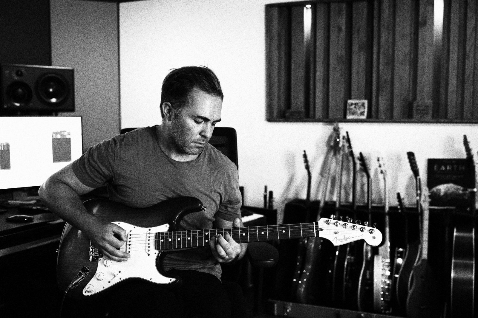 Paul Saunderson recording guitar in his studio